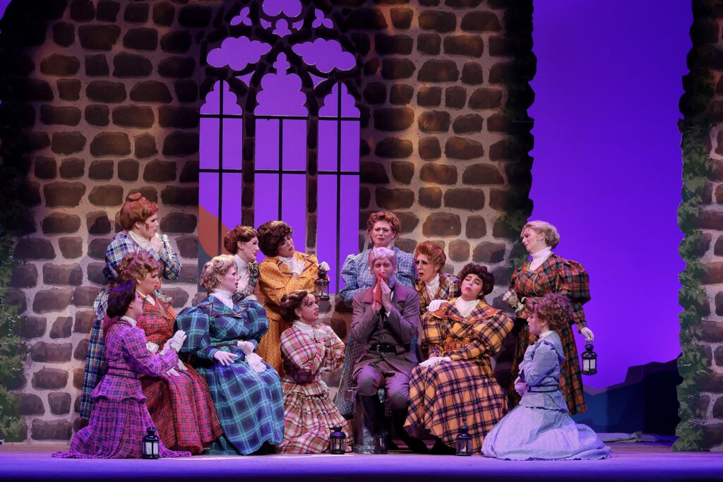 Maj. Gen. Stanely (Dennis Arrowsmith) laments telling a terrible story to the pirates while his daughters urge him to dry his glistening tear.