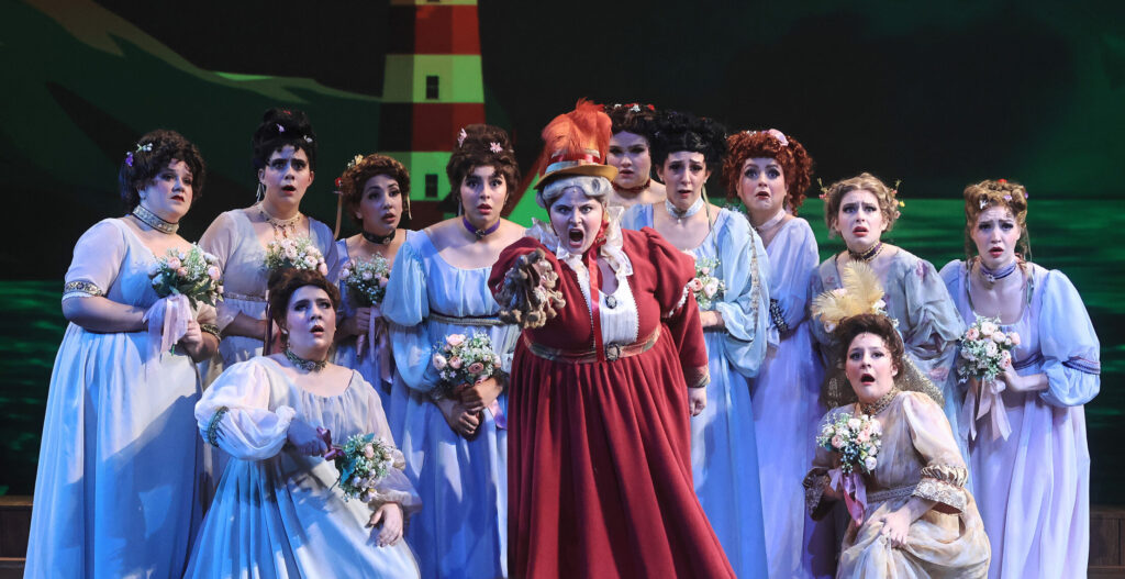 Scene from Ruddigore with Dame Hannah (Jana Elsworth) telling the ladies chorus the story of the curse